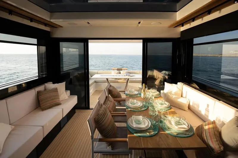 Slide: The Image of Luxurious interior of 2026 De Antonio Yachts D60, featuring elegant dining setup and ocean view. - 31