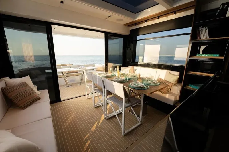 Slide: The Image of Luxurious interior of 2026 De Antonio Yachts D60 with elegant dining setup and ocean view. - 32