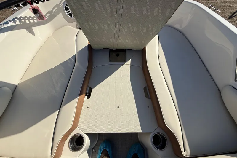 Slide: The Image of 2023 Stingray 192 DC boat interior with cushioned seating and mounted equipment. - 17