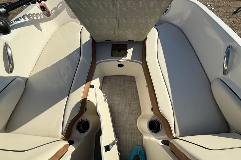 Slide: The Image of 2023 Stingray 192 DC boat interior with beige seating and mounted equipment. - 18