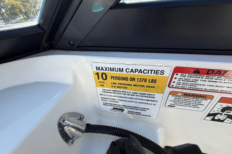 Slide: The Image of 2023 Stingray 192 DC boat with Minn Kota motor in parking lot. - 31