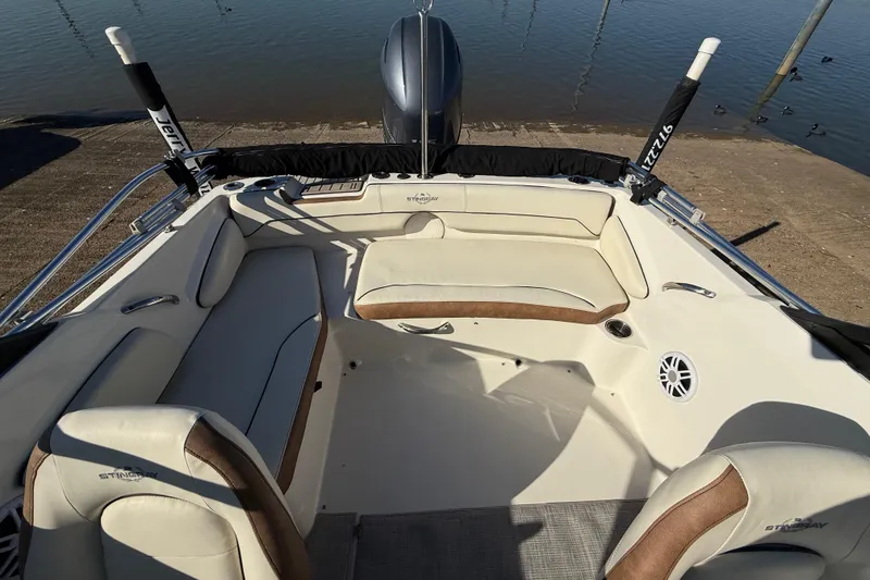 Slide: The Image of 2023 Stingray 192 DC boat interior with steering wheel and cushioned seat. - 35