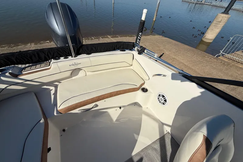 Slide: The Image of 2023 Stingray 192 DC boat interior with steering wheel and cushioned seat. - 36