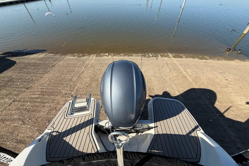 Slide: The Image of 2023 Stingray 192 DC boat dashboard with steering wheel and gauges. - 38