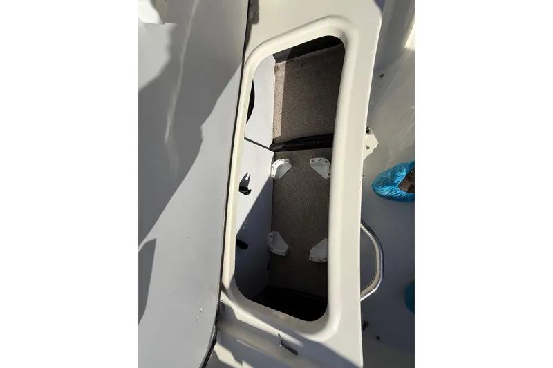 Slide: The Image of 2023 Stingray 192 DC boat interior with white cushioned seating and speaker. - 39