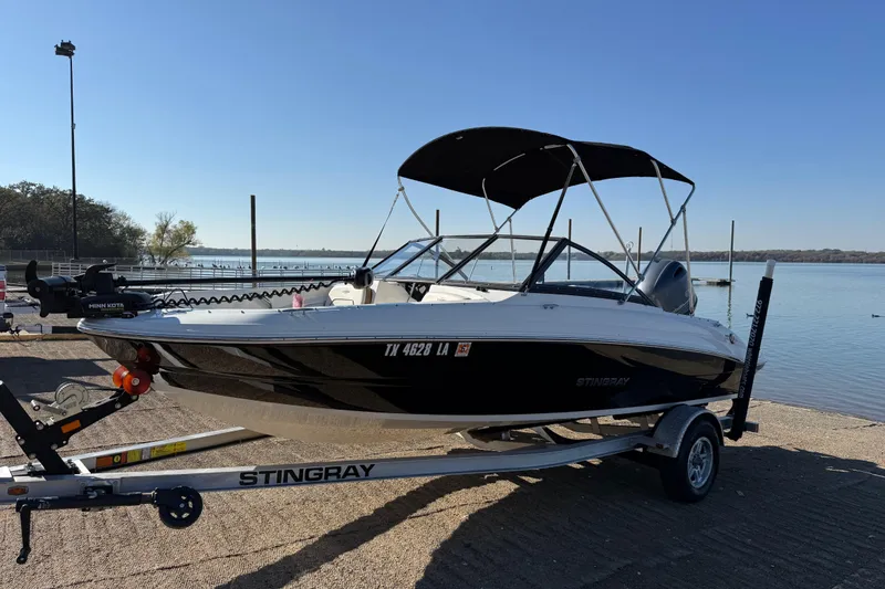 Slide: The Image of 2023 Stingray 192 DC boat at a boat ramp, ready for launch. - 43