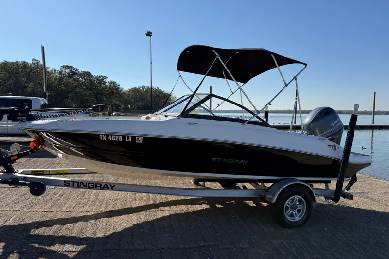 Slide: The Image of 2023 Stingray 192 DC boat storage compartment with battery and accessories. - 45