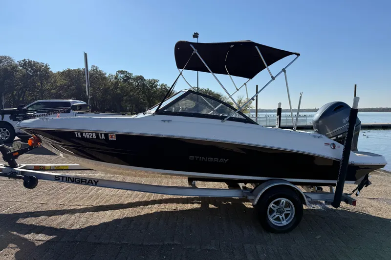 Slide: The Image of 2023 Stingray 192 DC boat battery compartment with marine battery and wiring. - 46