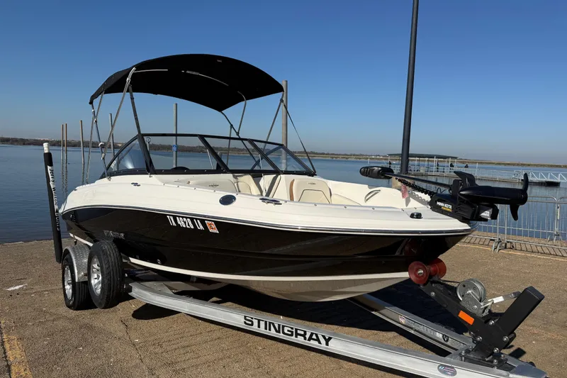 Slide: The Image of Hand holding bubble-wrapped item on 2023 Stingray C 192 boat interior. - 68