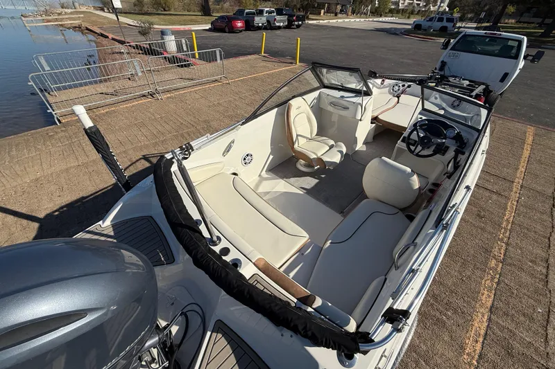 Slide: The Image of 2023 Stingray 192 DC boat with Yamaha engine on trailer by the water. - 8