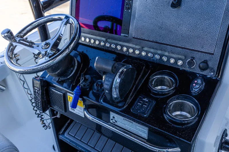 Slide: The Image of Control panel of 2018 Crevalle 26 Open boat with steering wheel and electronics. - 11