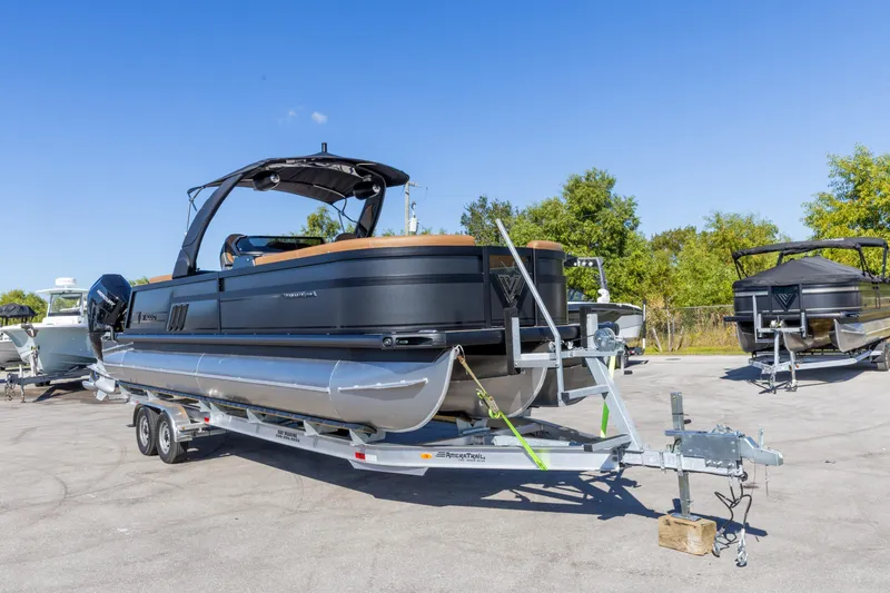 Slide: The Image of 2026 Viaggio Diamante UWA pontoon boat on trailer, parked outdoors under clear blue sky. - 15