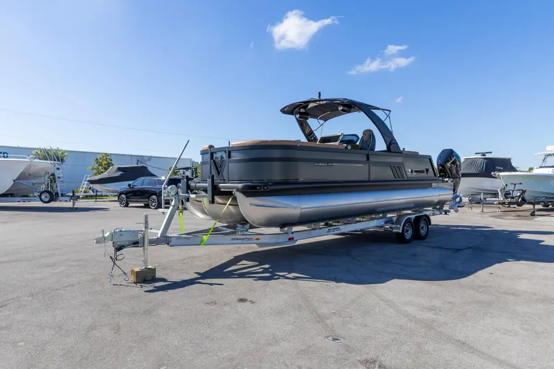 Slide: The Image of 2026 Viaggio Diamante UWA pontoon boat on trailer under clear blue sky. - 17