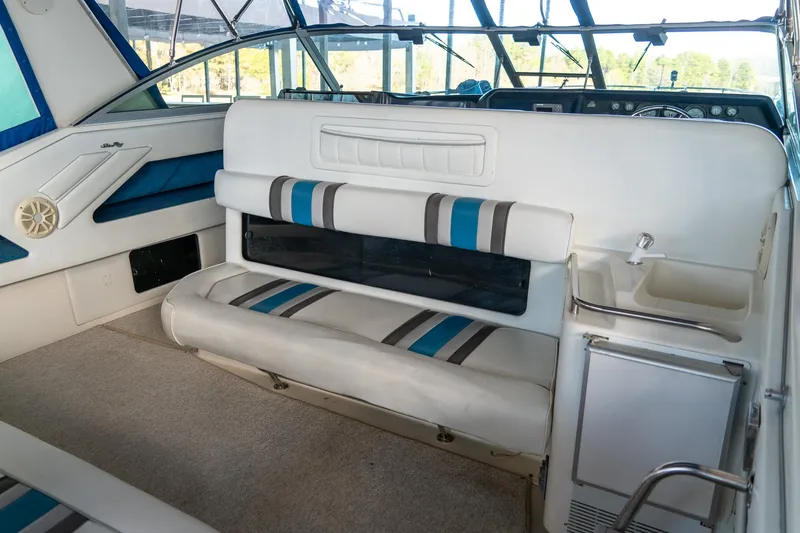 Slide: The Image of Interior of 1991 Sea Ray 350 Sundancer boat with cushioned seating and dashboard. - 10