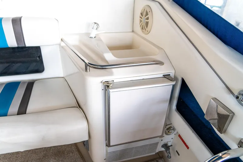 Slide: The Image of Interior of 1991 Sea Ray 350 Sundancer with sink and seating area. - 11