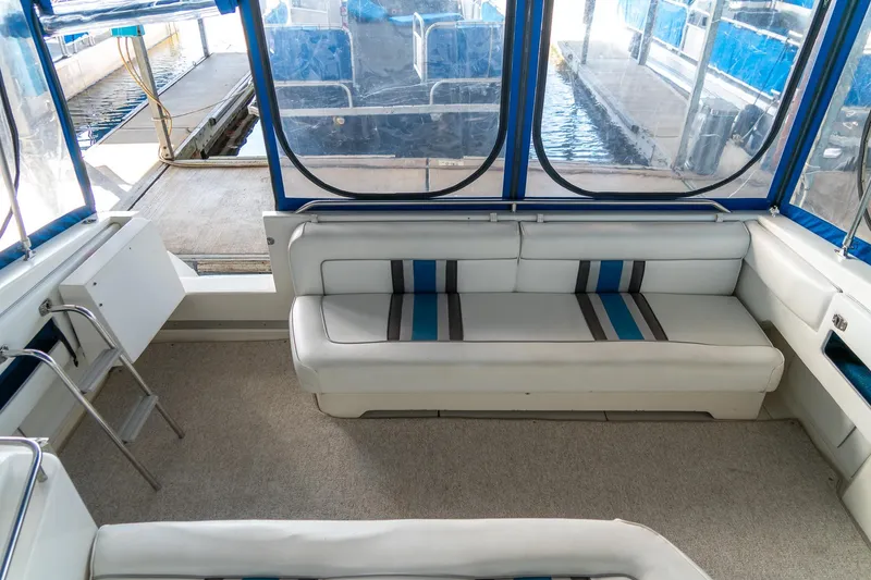 Slide: The Image of Interior of 1991 Sea Ray 350 Sundancer with white seating and blue accents. - 14