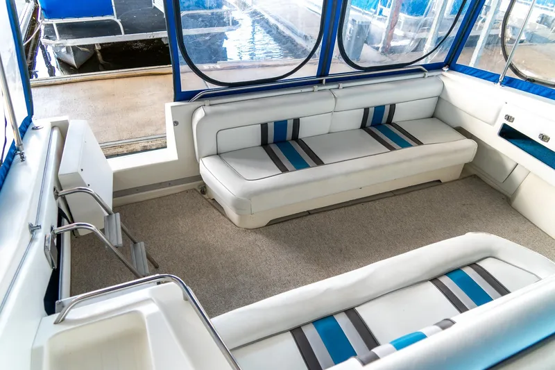 Slide: The Image of Interior of 1991 Sea Ray 350 Sundancer boat with white and blue seating. - 15