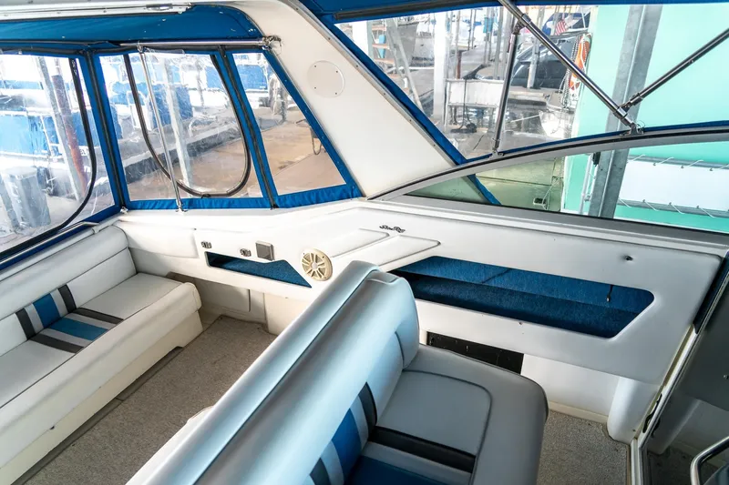 Slide: The Image of Interior of 1991 Sea Ray 350 Sundancer boat with blue and white seating. - 16