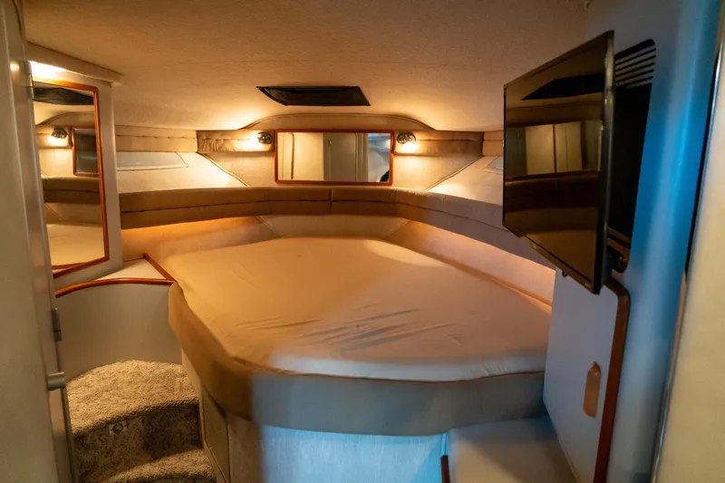 Slide: The Image of Cozy interior cabin of 1991 Sea Ray 350 Sundancer with bed and TV. - 23