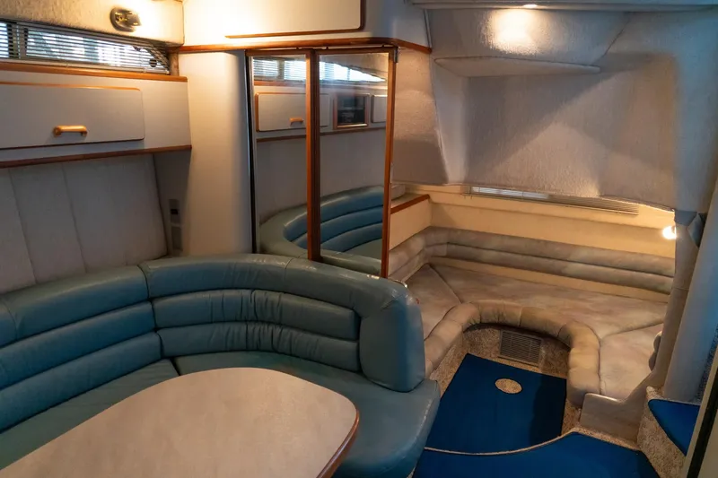 Slide: The Image of Interior of 1991 Sea Ray 350 Sundancer yacht with blue seating and cozy layout. - 28