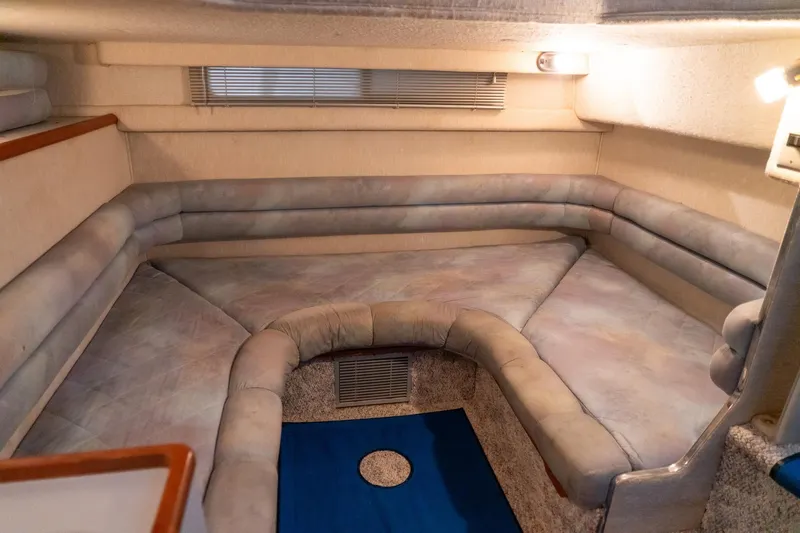 Slide: The Image of 1991 Sea Ray 350 Sundancer cabin interior with cushioned seating and soft lighting. - 30