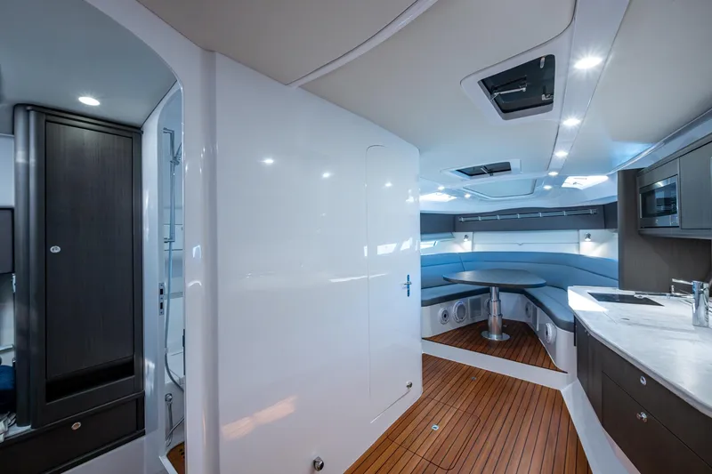 Slide: The Image of Luxurious interior of 2024 Intrepid 477 Evolution yacht with modern kitchen and seating area. - 11