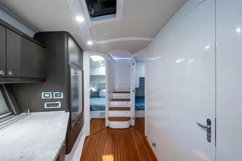 Slide: The Image of Luxurious interior of 2024 Intrepid 477 Evolution yacht with modern design and wood flooring. - 12