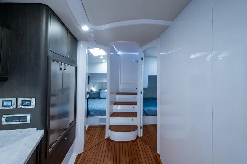 Slide: The Image of Luxurious interior of 2024 Intrepid 477 Evolution yacht with modern design and wooden flooring. - 15