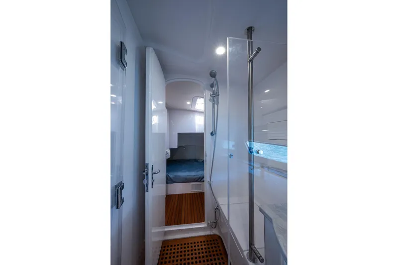 Slide: The Image of Luxurious interior of 2024 Intrepid 477 Evolution yacht, featuring sleek shower and cozy cabin. - 16