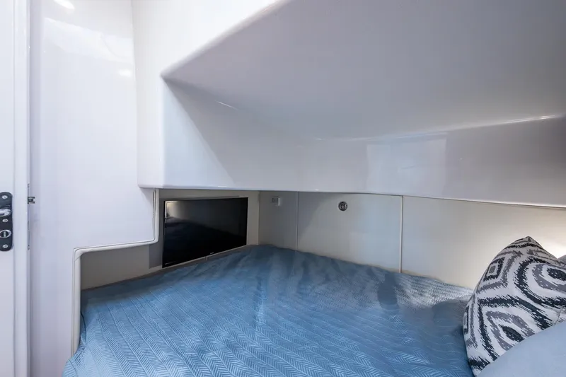 Slide: The Image of 2024 Intrepid 477 Evolution cabin interior with bed, pillow, and sleek design. - 18