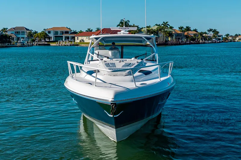 Slide: The Image of 2024 Intrepid 477 Evolution yacht cruising in a scenic waterfront setting. - 3