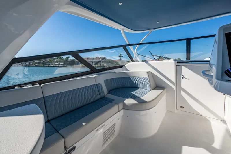 Slide: The Image of Luxurious interior of 2024 Intrepid 477 Evolution yacht with elegant seating and panoramic windows. - 32