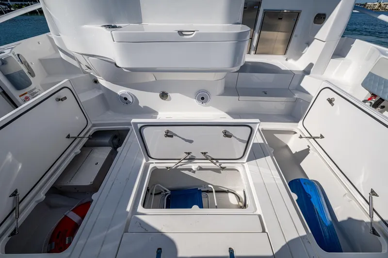 Slide: The Image of 2024 Intrepid 477 Evolution boat interior with open storage compartments. - 42