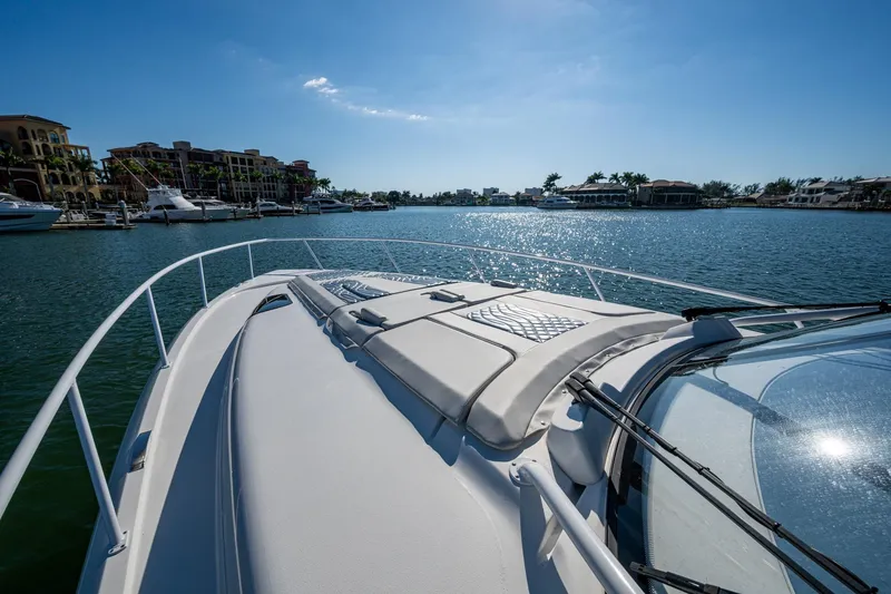 Slide: The Image of 2024 Intrepid 477 Evolution yacht cruising in sunny marina waters. - 43