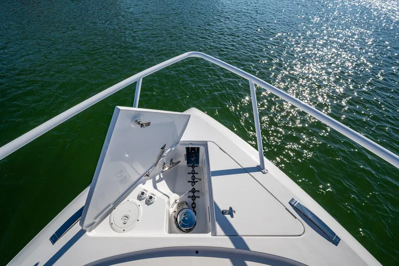 Slide: The Image of Bow view of 2024 Intrepid 477 Evolution yacht on sparkling water. - 47