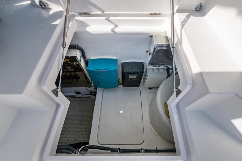 Slide: The Image of Engine compartment of 2024 Intrepid 477 Evolution boat, showcasing equipment and storage space. - 48