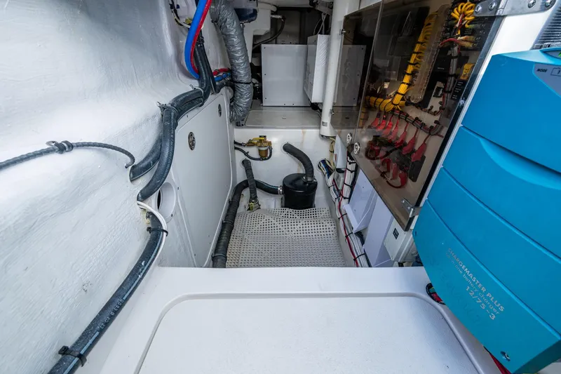 Slide: The Image of Engine room of 2024 Intrepid 477 Evolution boat, showcasing wiring and equipment. - 49