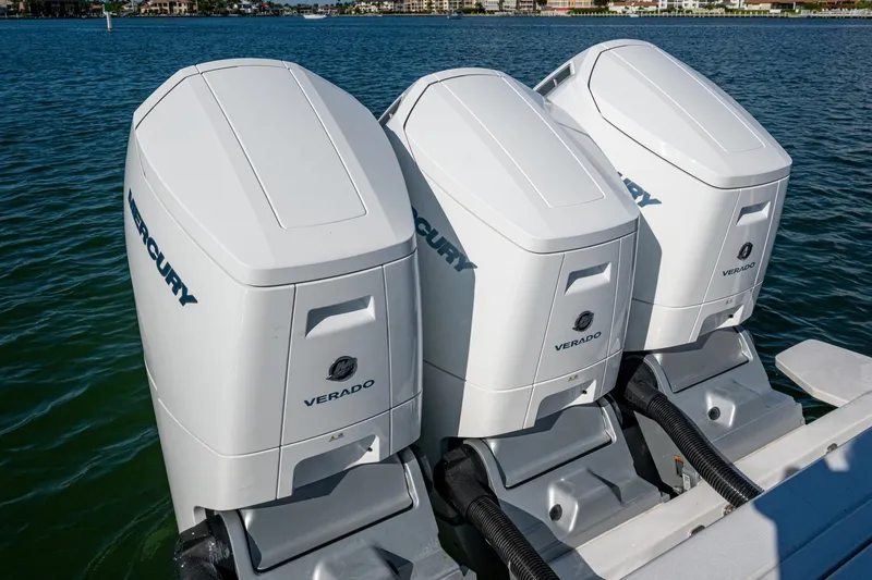 Slide: The Image of Triple Mercury Verado outboard engines on 2024 Intrepid 477 Evolution boat, docked on water. - 51