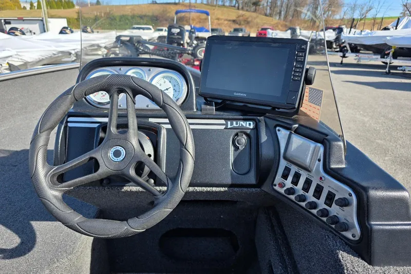 Slide: The Image of 2022 Lund 1675 Adventure SS dashboard with steering wheel and Garmin display. - 15