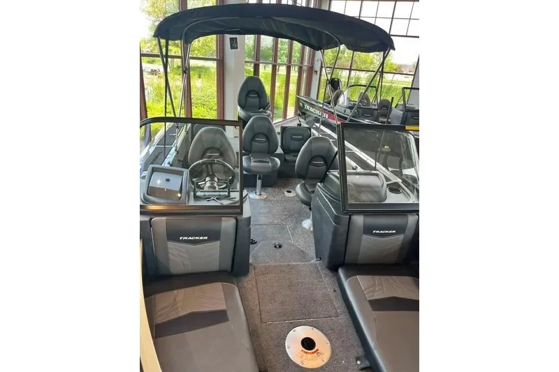 Slide: The Image of 2026 Tracker Targa V-18 Combo boat interior with seating and canopy. - 20