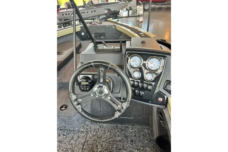 Slide: The Image of Steering console of 2026 Tracker Targa V-18 Combo boat with gauges and controls. - 18