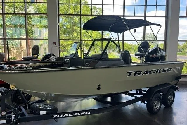 Slide: The Image of 2026 Tracker Targa V-18 Combo boat displayed indoors on a trailer. - 12
