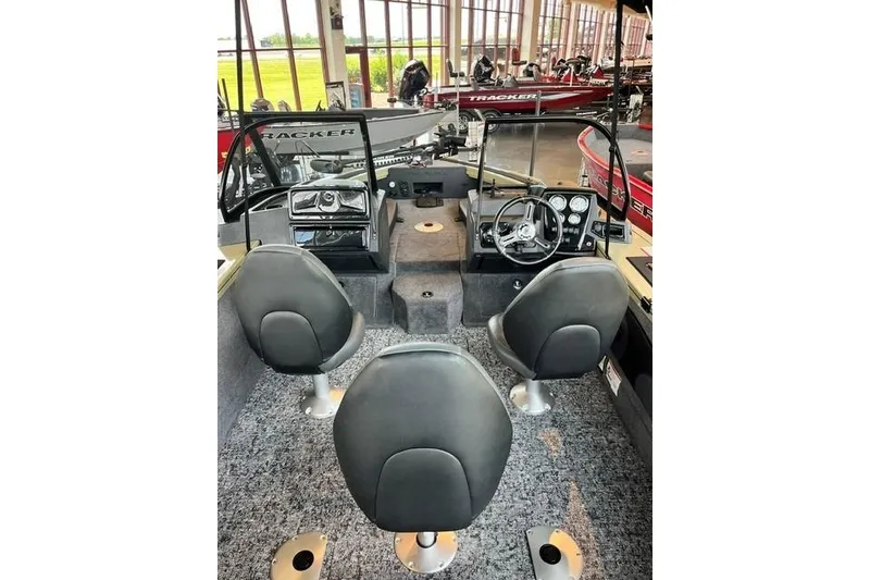 Slide: The Image of 2026 Tracker Targa V-18 Combo boat interior with seating and dashboard view. - 14