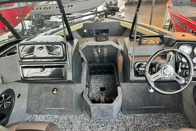 Slide: The Image of 2026 Tracker Targa V-18 Combo boat interior with steering wheel and dashboard controls. - 17