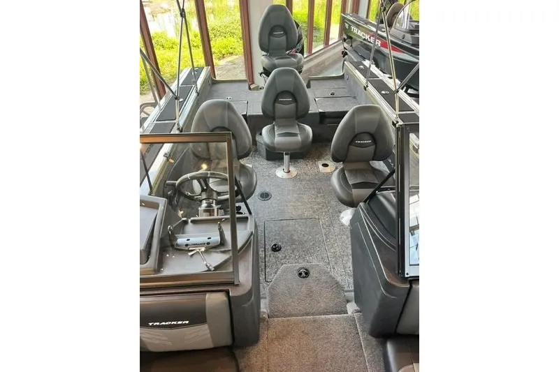 Slide: The Image of 2026 Tracker Targa V-18 Combo boat interior with seating and steering console. - 15