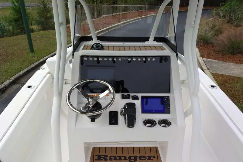 Slide: The Image of 2026 Ranger 2660 Bay boat dashboard with steering wheel and navigation controls. - 7