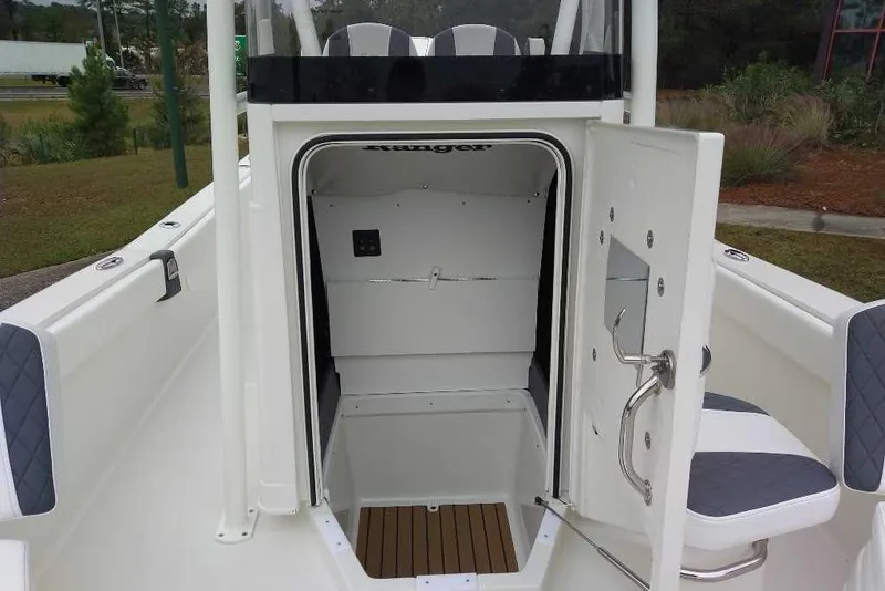 Slide: The Image of 2026 Ranger 2660 Bay boat interior with open cabin door, showcasing seating and storage. - 8