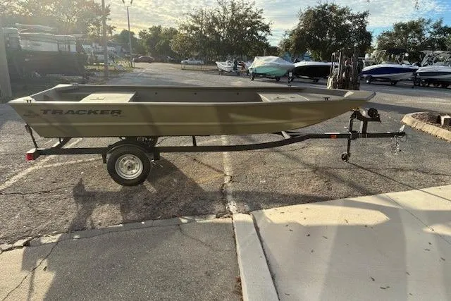 Slide: The Image of 2026 Tracker Grizzly 1648 Utility boat on trailer in parking lot. - 2