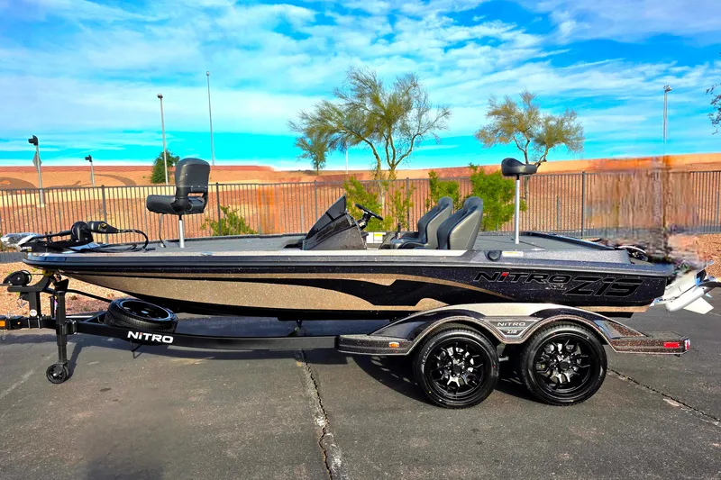 The Image of 2026 Nitro Z19 XL boat on trailer, parked outdoors under clear blue sky. - 0