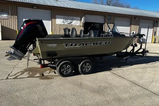 The Image of 2026 Tracker Targa V-19 Combo boat on trailer, parked outside a warehouse. - 1